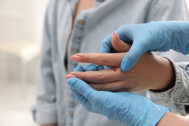 Photo of Doctor examining woman's moles in hospital, closeup