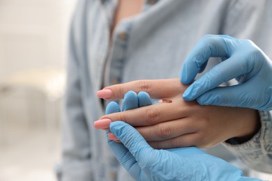 Photo of Doctor examining woman's moles in hospital, closeup
