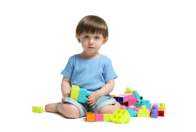 Photo of Cute little boy playing with building bricks on white background