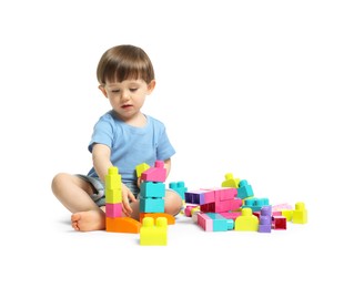 Photo of Cute little boy playing with building bricks on white background