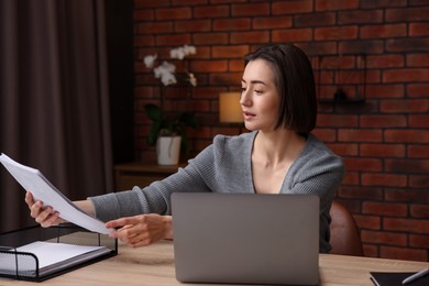 Photo of Woman working at desk in home office