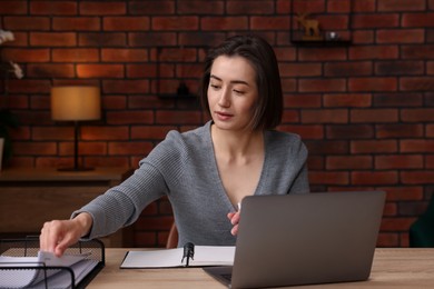 Photo of Woman working at desk in home office