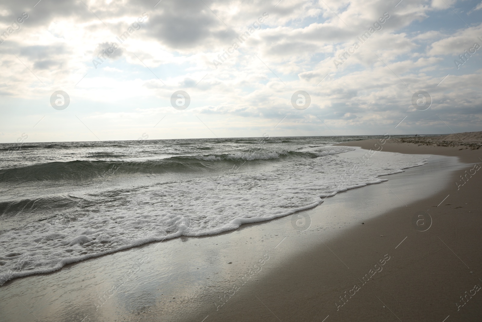 Sea waves rolling onto sandy tropical beach Photo of Sea waves rolling onto sandy tropical beach