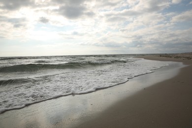 Photo of Sea waves rolling onto sandy tropical beach