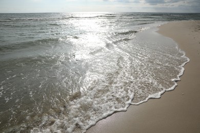 Photo of Sea waves rolling onto sandy tropical beach