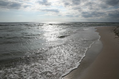 Photo of Sea waves rolling onto sandy tropical beach