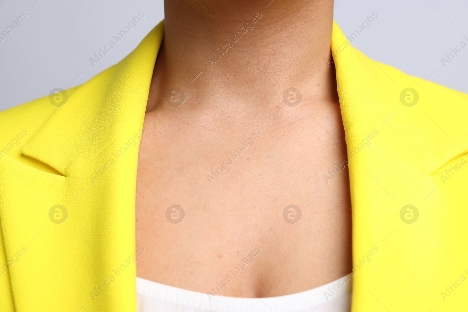 Photo of Young woman with healthy skin on light grey background, closeup