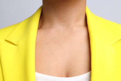 Photo of Young woman with healthy skin on light grey background, closeup