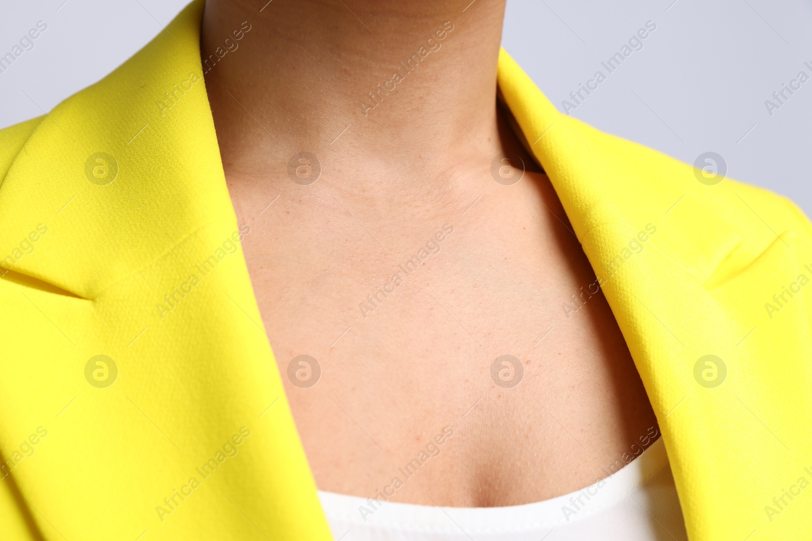 Photo of Young woman with healthy skin on light grey background, closeup