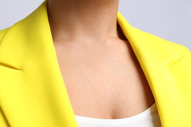 Photo of Young woman with healthy skin on light grey background, closeup