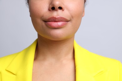 Photo of Young woman with healthy skin on light grey background, closeup