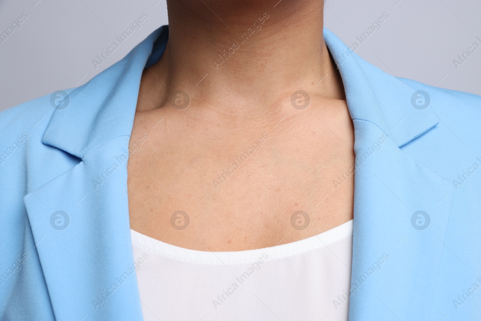 Photo of Young woman with healthy skin on light grey background, closeup