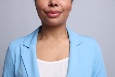 Photo of Young woman with healthy skin on light grey background, closeup
