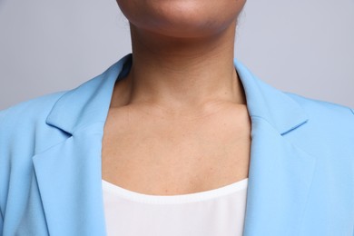 Photo of Young woman with healthy skin on light grey background, closeup