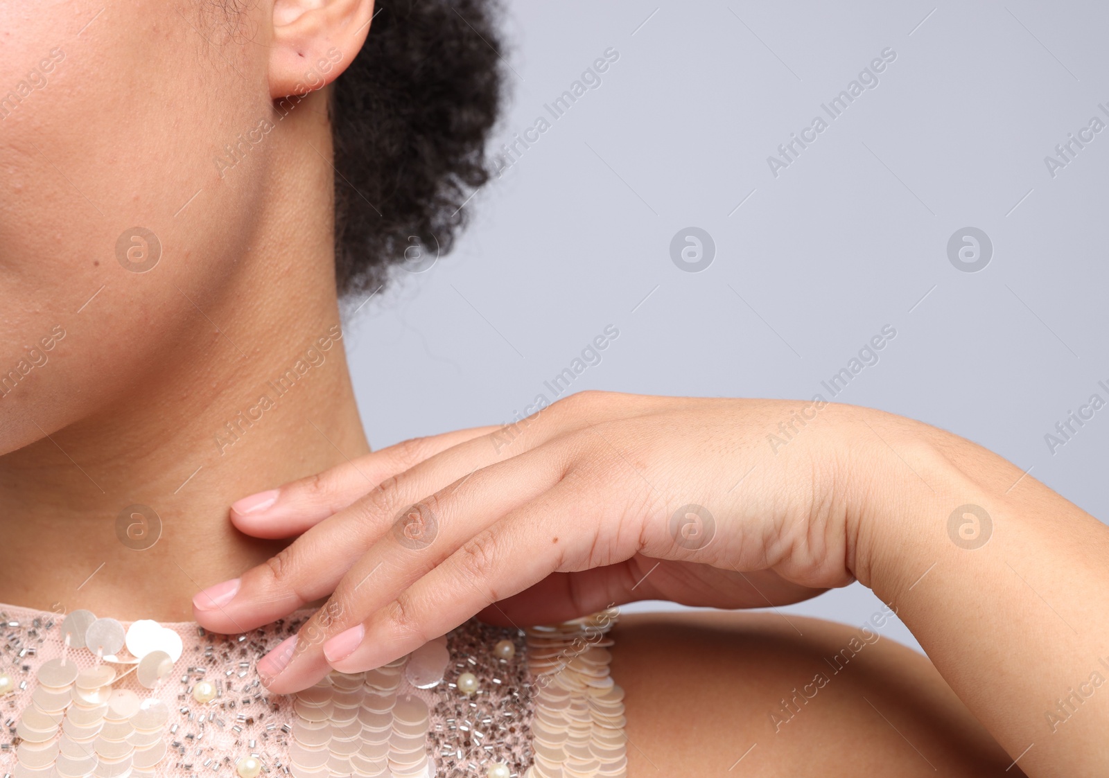 Photo of Young woman with healthy skin on light grey background, closeup. Space for text