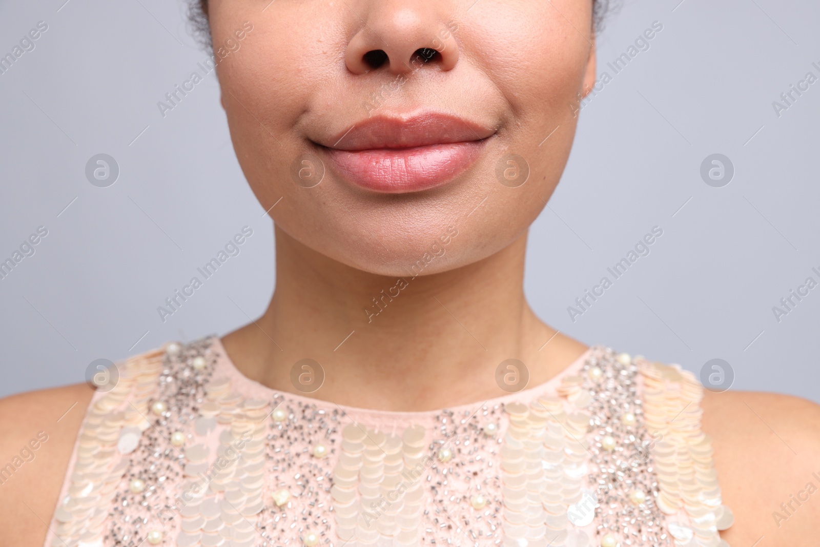 Photo of Young woman with healthy skin on light grey background, closeup