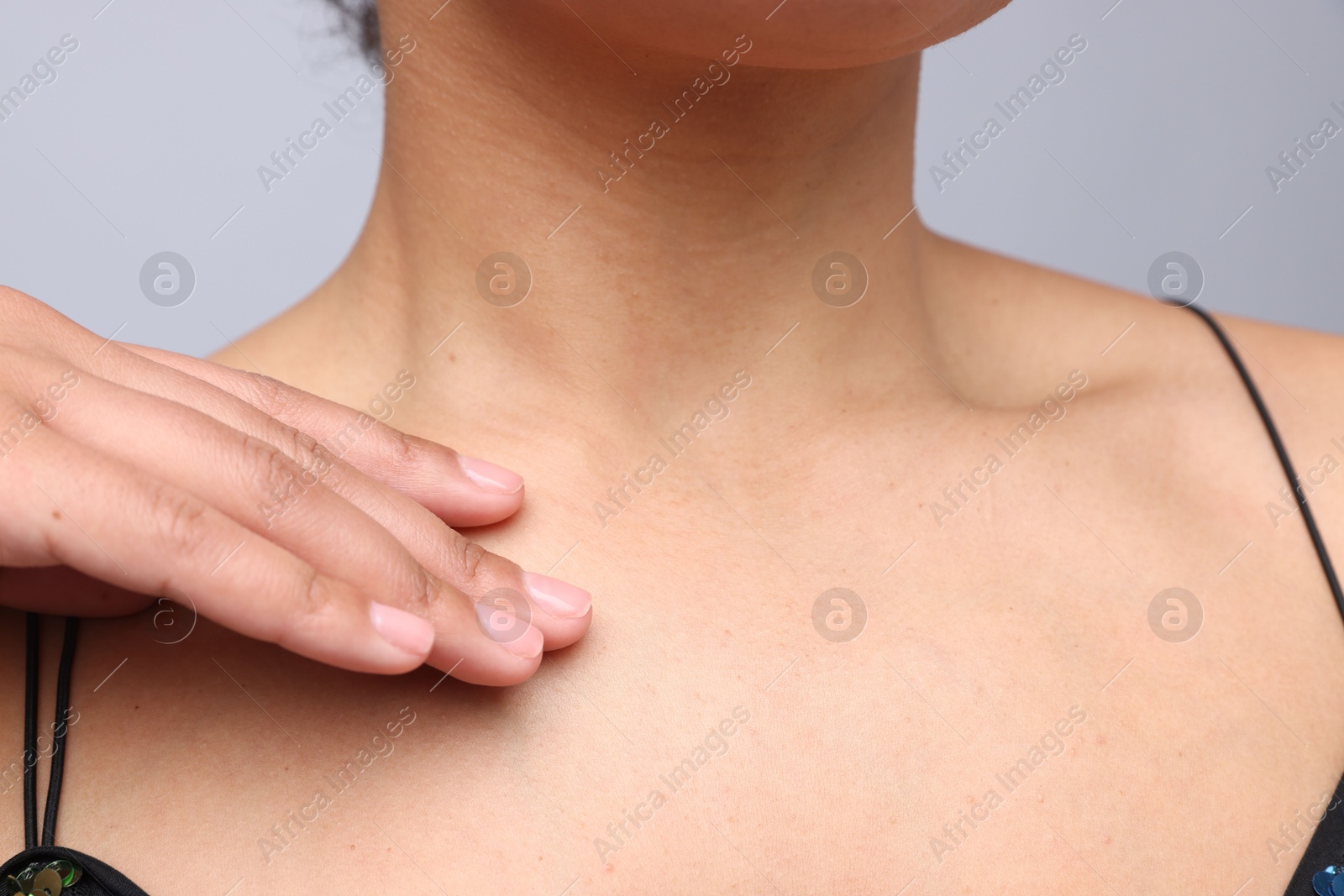 Photo of Young woman with healthy skin on light grey background, closeup