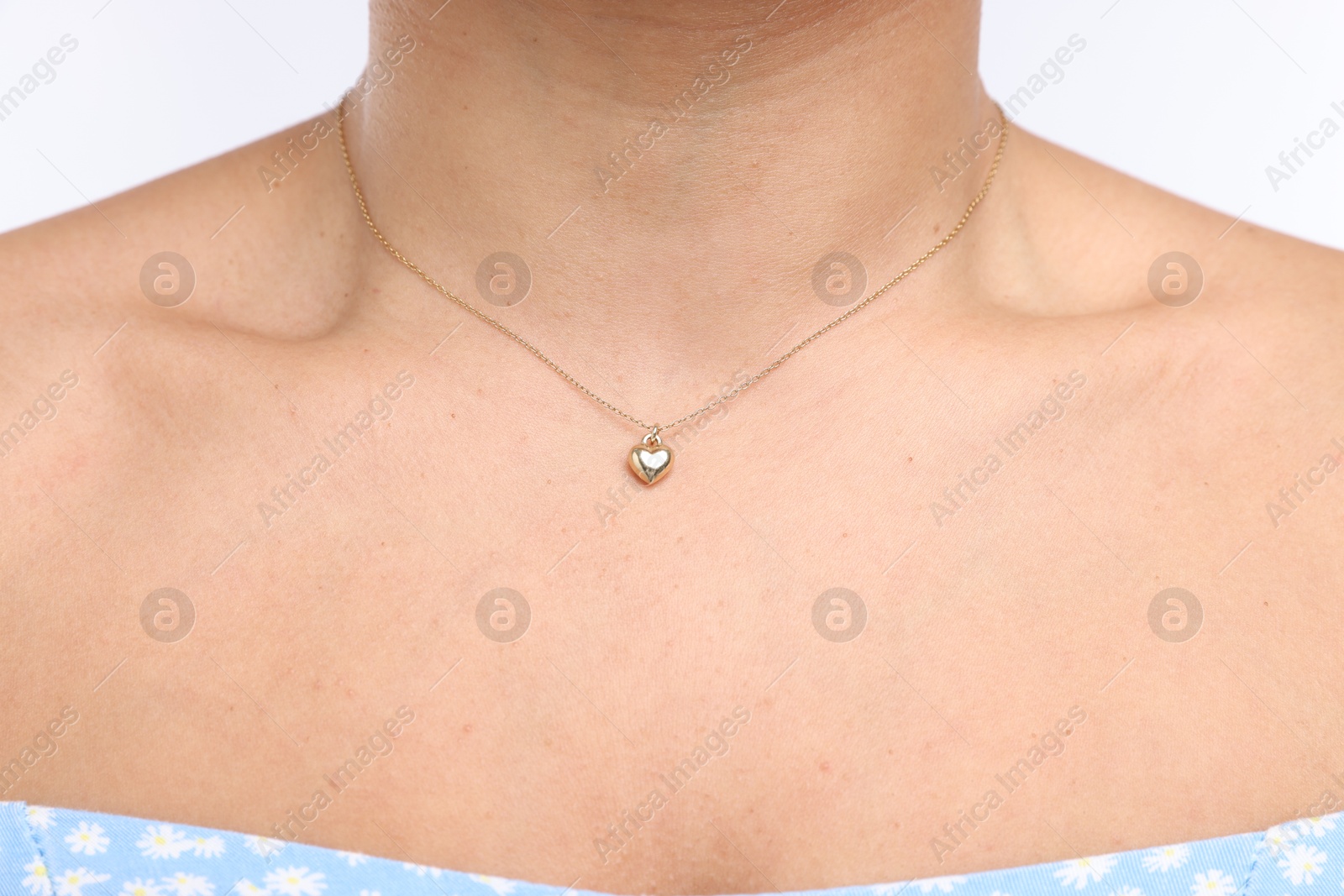 Photo of Young woman wearing elegant gold necklace on white background, closeup