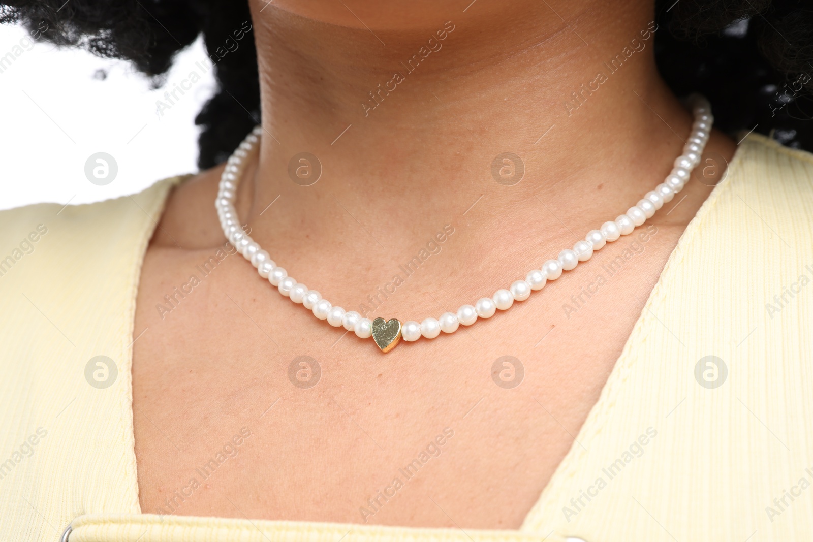 Young woman wearing elegant pearl necklace on white background, closeup Photo of Young woman wearing elegant pearl necklace on white background, closeup