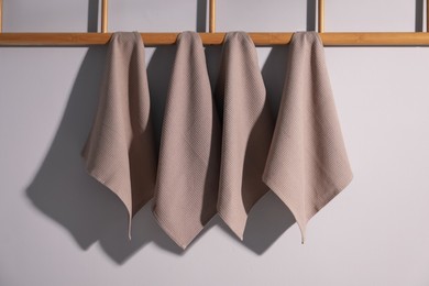 Photo of Clean waffle towels hanging on light wall