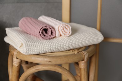 Photo of Clean waffle towels on chair in bathroom, closeup