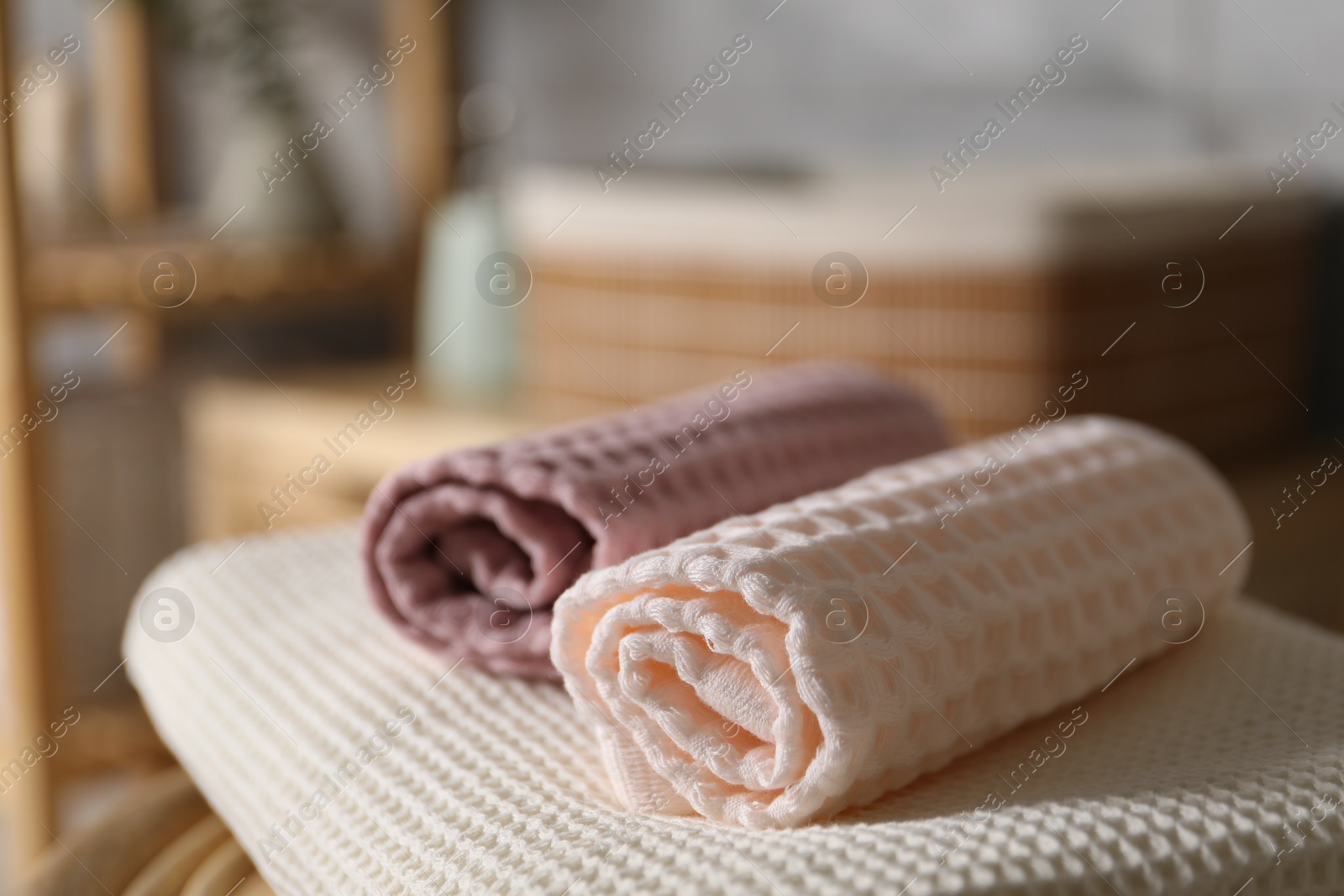 Clean waffle towels on chair in bathroom, closeup Photo of Clean waffle towels on chair in bathroom, closeup