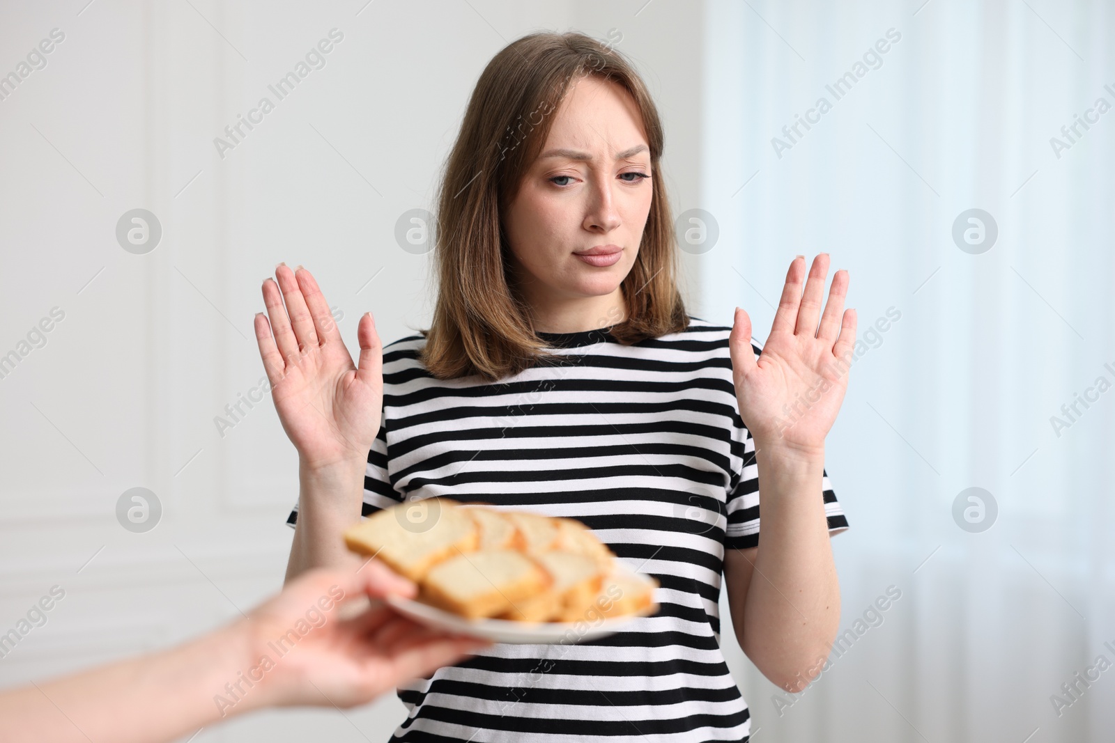 Photo of Gluten free diet. Woman refusing from bread indoors
