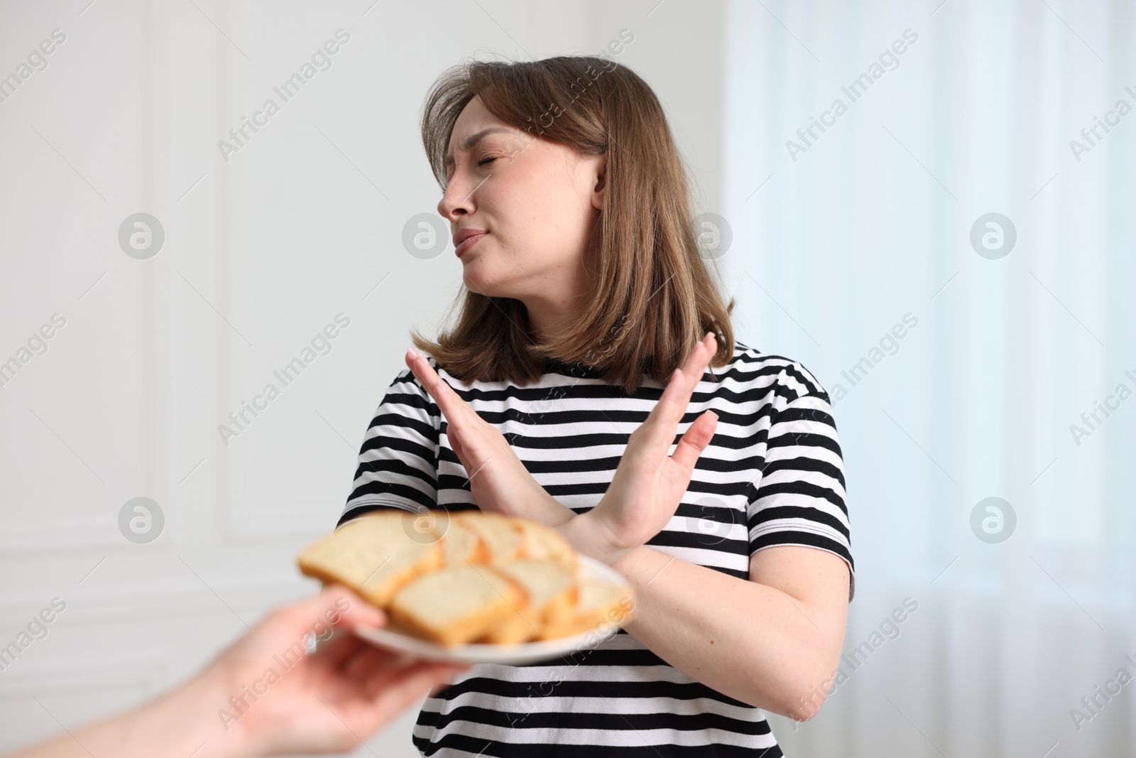 Photo of Gluten free diet. Woman refusing from bread indoors