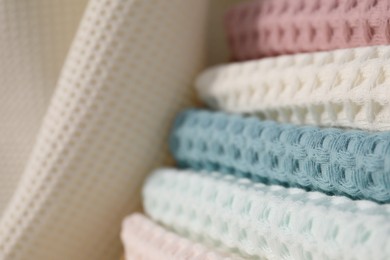 Photo of Texture of stacked waffle towels as background, closeup