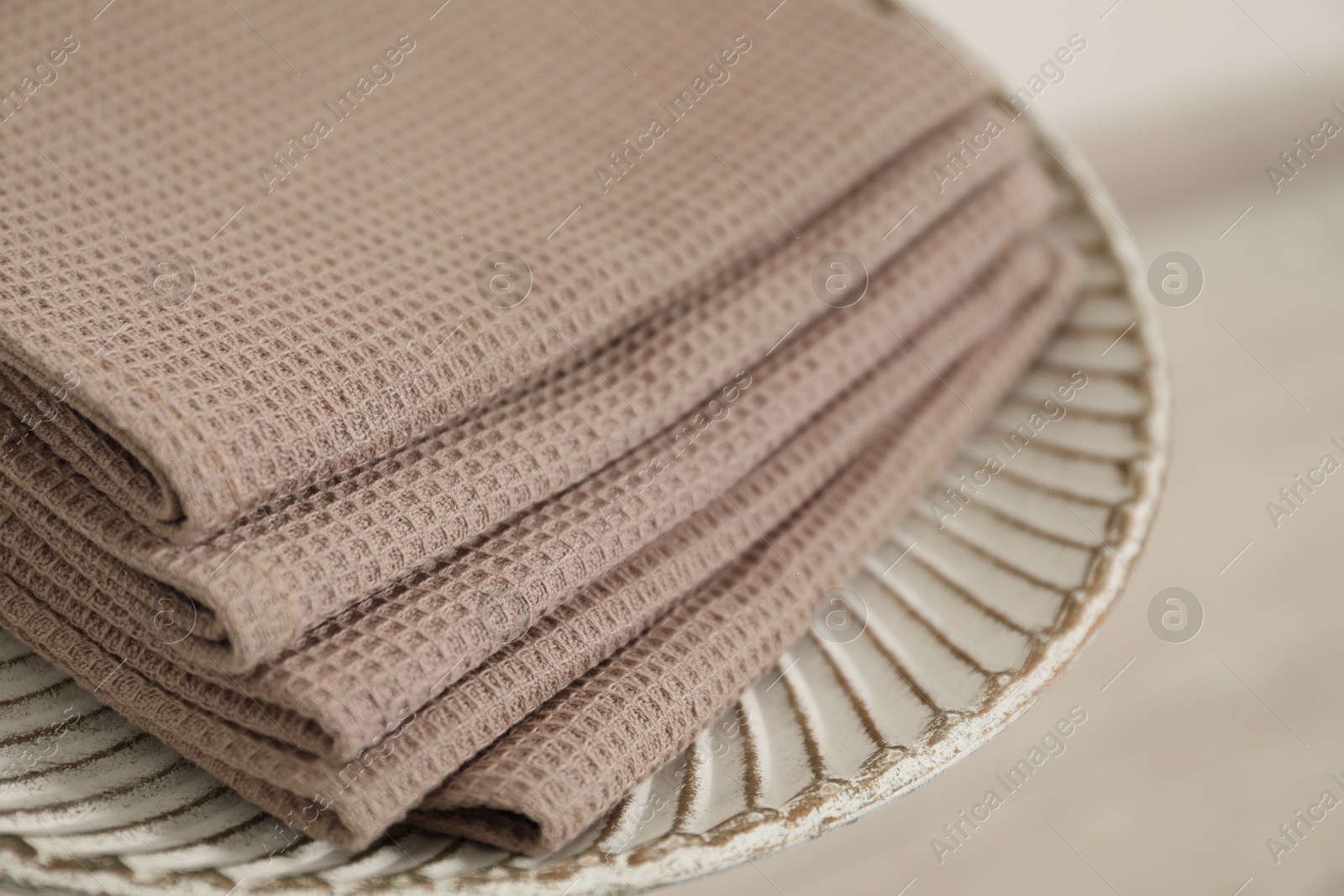 Photo of Clean waffle towels on side table against blurred background, closeup