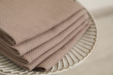 Photo of Clean waffle towels on side table against blurred background, closeup