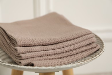 Photo of Clean waffle towels on side table against blurred background, closeup