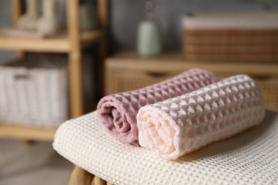 Photo of Clean waffle towels on chair in bathroom, closeup