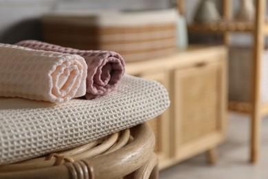 Photo of Clean waffle towels on chair in bathroom, closeup