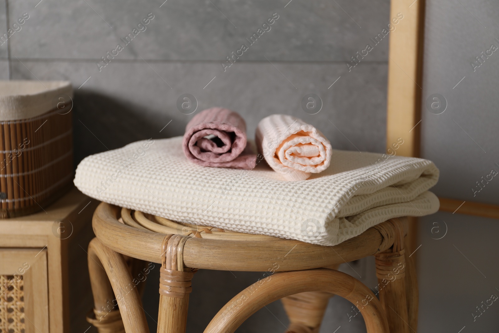 Clean waffle towels on chair in bathroom, closeup Photo of Clean waffle towels on chair in bathroom, closeup
