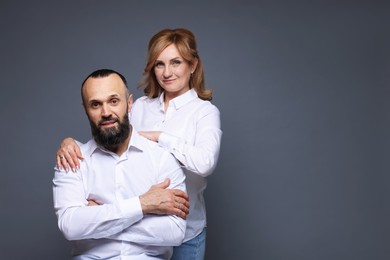Photo of Portrait of lovely couple on grey background, space for text