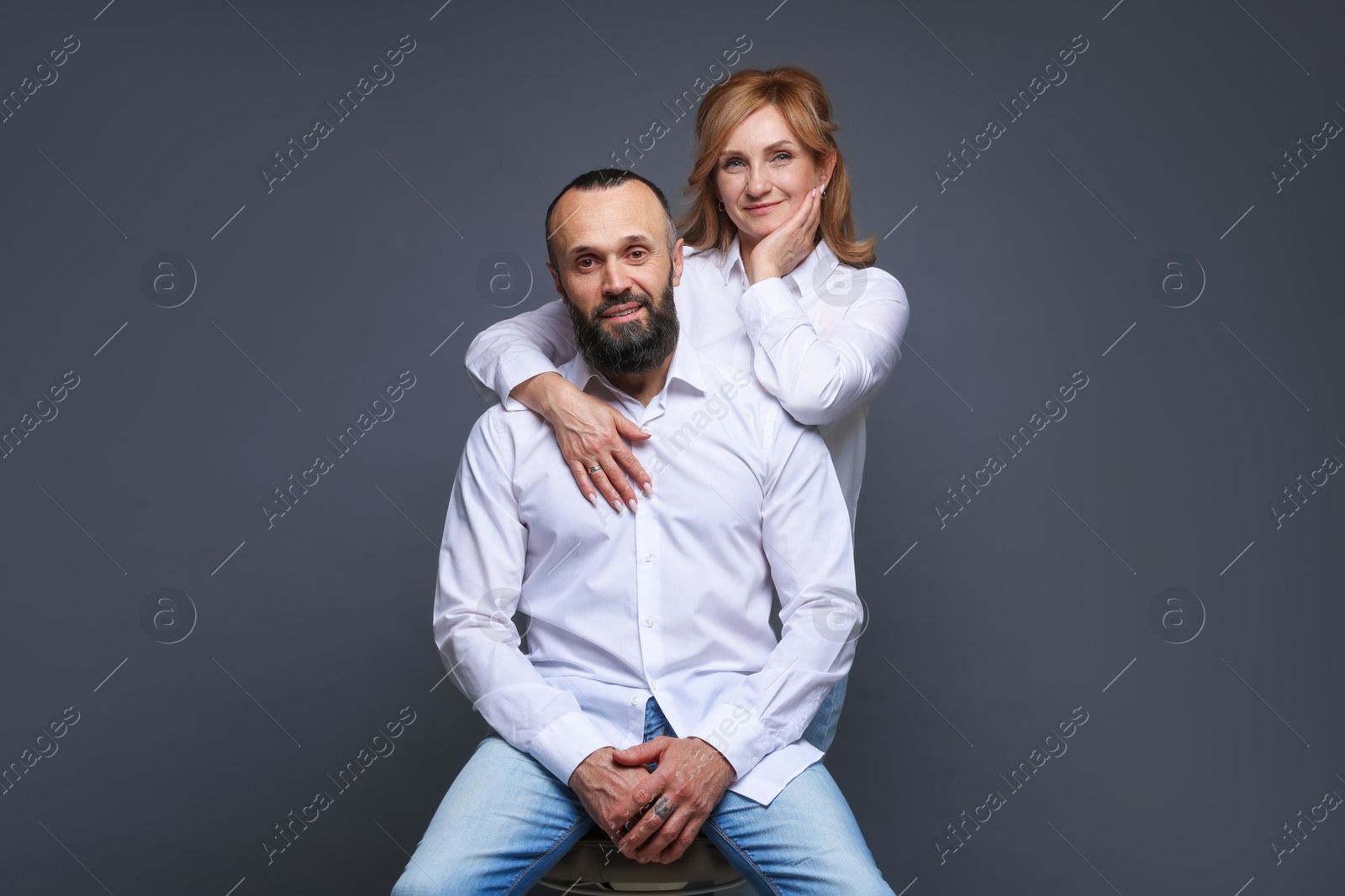 Photo of Portrait of lovely couple on grey background