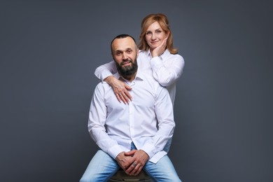 Photo of Portrait of lovely couple on grey background
