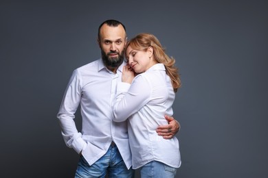 Photo of Portrait of lovely couple on grey background