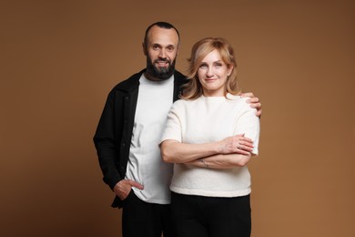 Photo of Portrait of lovely couple on brown background