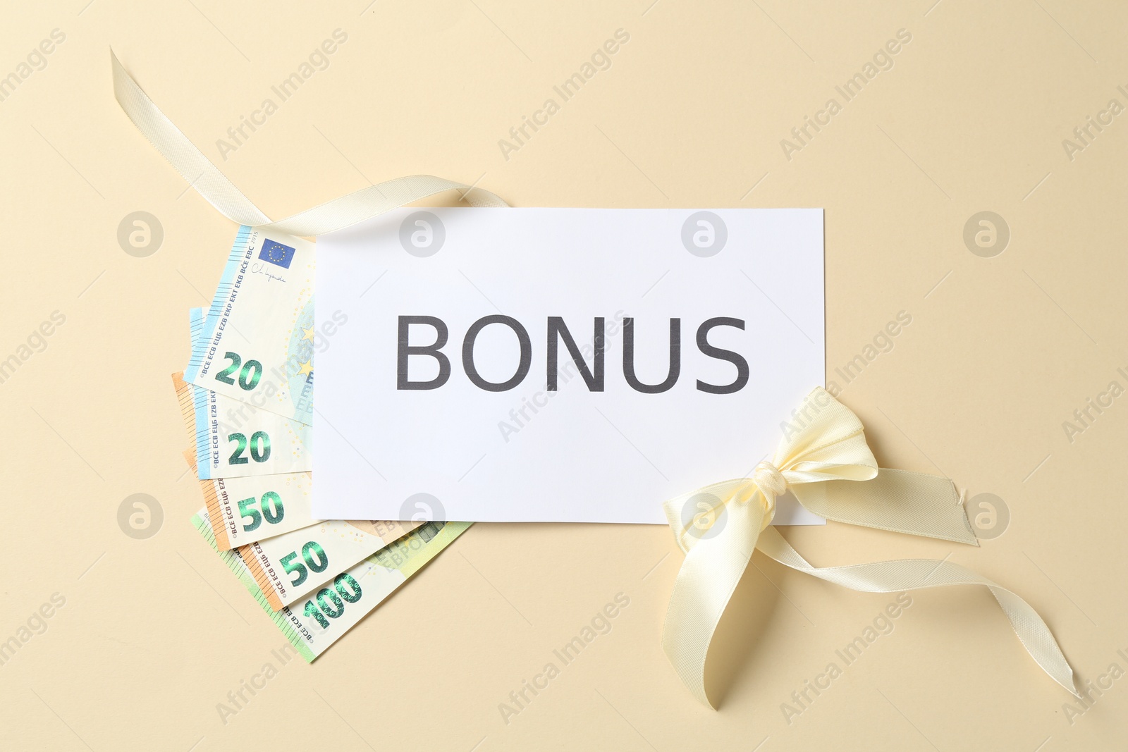 Card with word Bonus, euro banknotes and bow on beige background, flat lay Photo of Card with word Bonus, euro banknotes and bow on beige background, flat lay