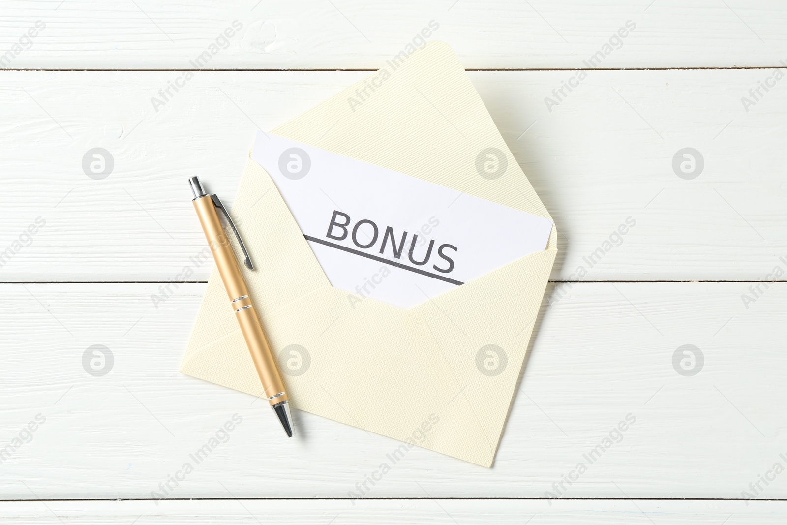 Envelope, card with word Bonus and pen on white wooden table, top view Photo of Envelope, card with word Bonus and pen on white wooden table, top view