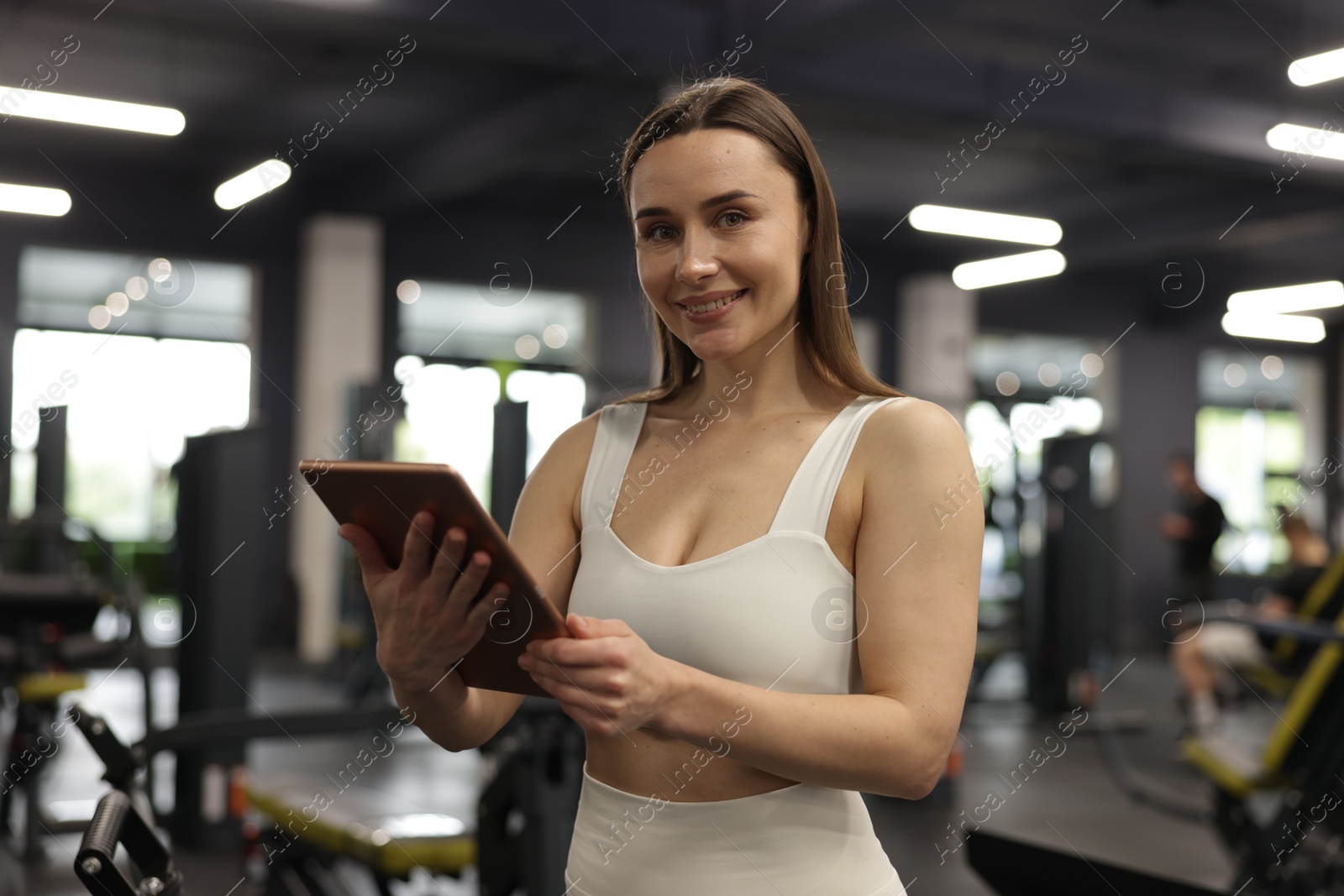 Photo of Personal trainer with tablet in sport center