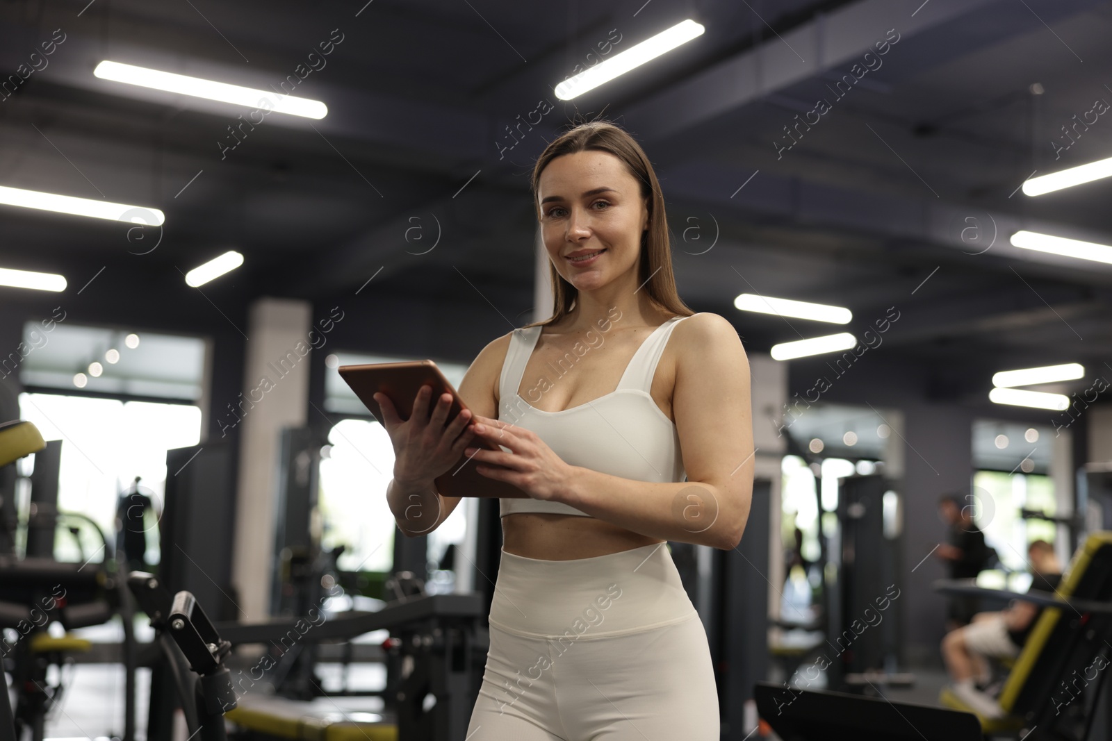 Photo of Personal trainer with tablet in sport center