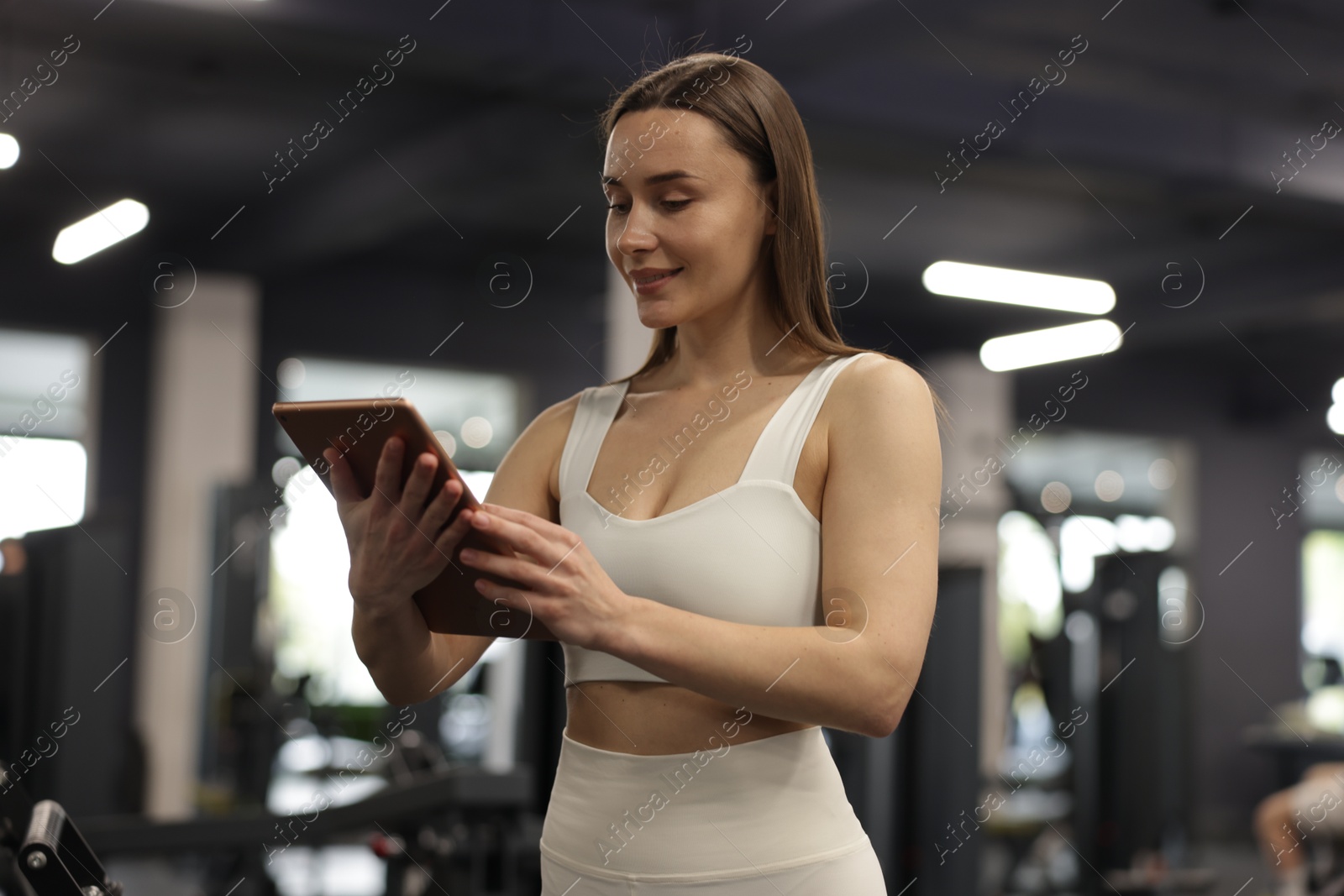 Photo of Personal trainer with tablet in sport center