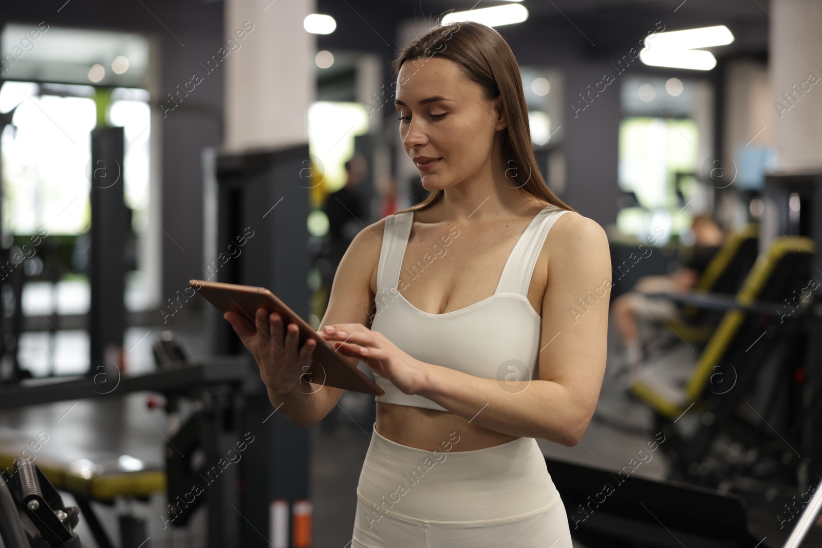 Photo of Personal trainer with tablet in sport center