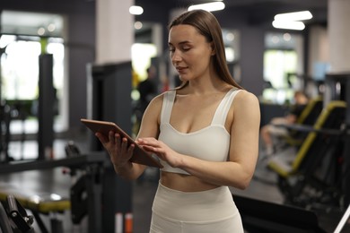 Photo of Personal trainer with tablet in sport center