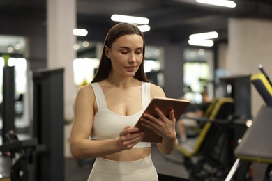 Photo of Personal trainer with tablet in sport center