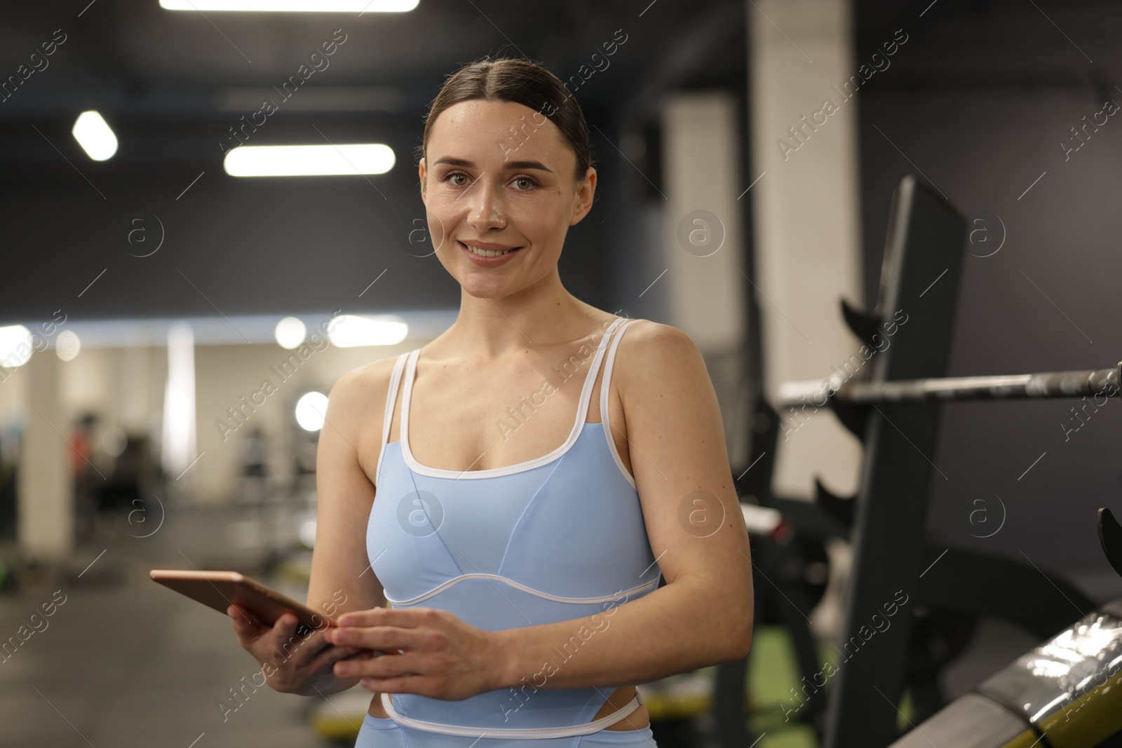 Photo of Professional personal trainer with tablet in gym