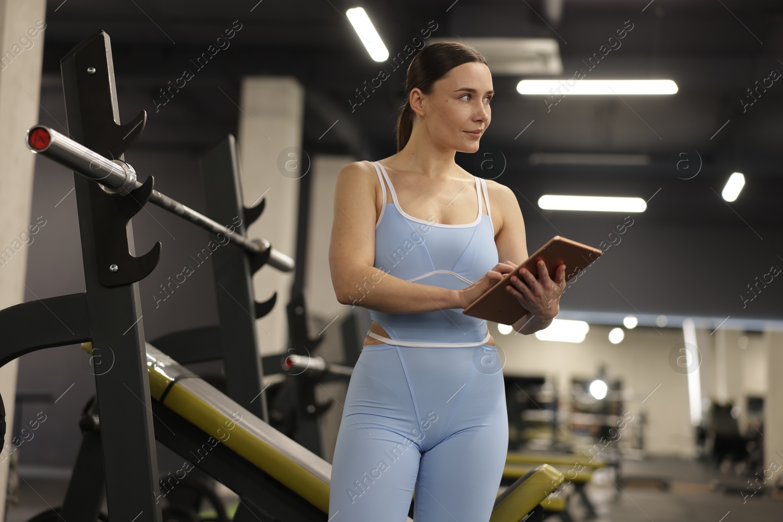 Photo of Professional personal trainer with tablet in gym